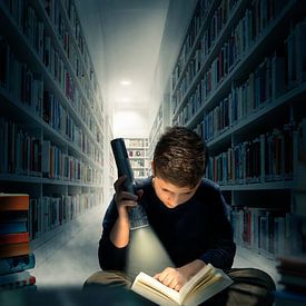 Boy reading in the dark in a library, by Jürgen Neugebauer | createyour.photo