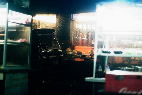 Einsamer Mann im Restaurant, während es draußen regnet