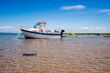 White boat on sand by Youri Mahieu