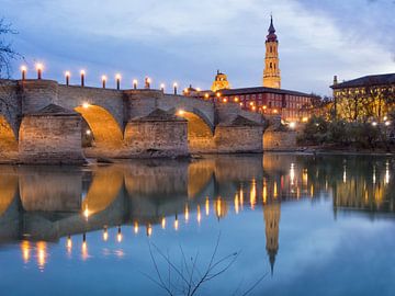 Medieval bridge and El Salvador cathedral (La Seo) reflecting on the Ebro river. by Carlos Charlez