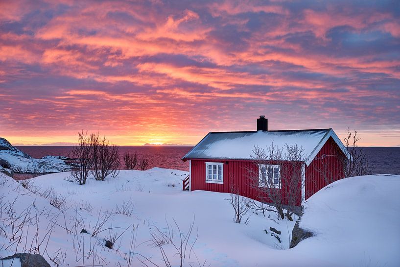 red hut in winter landscape in front of sea in atmospheric sunrise with clouds by Jürgen Ritterbach