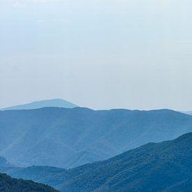 Far landscape of the Carpathian Mountains against a blue sky by AS Photography