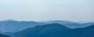 Far landscape of the Carpathian Mountains against a blue sky