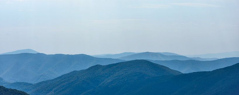 Far landscape of the Carpathian Mountains against a blue sky by AS Photography
