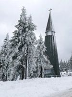 The church of Rogla in the Slovenian Alps in a snowy landscape.