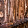 Old wooden door of a barn by Remco Bosshard