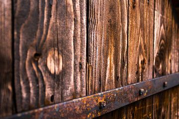 Old wooden door of a barn by Remco Bosshard