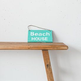Wooden bench with Beach house sign by Marie-José Brandsen