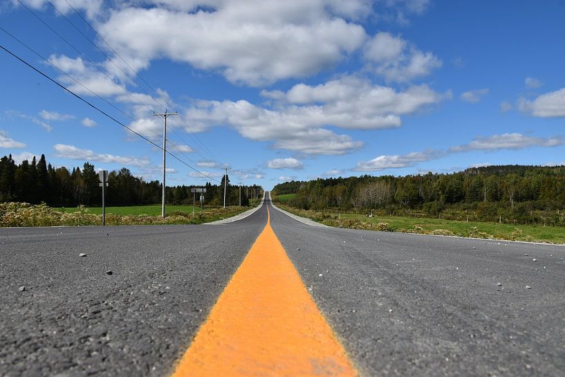 A country road under blue skies by Claude Laprise