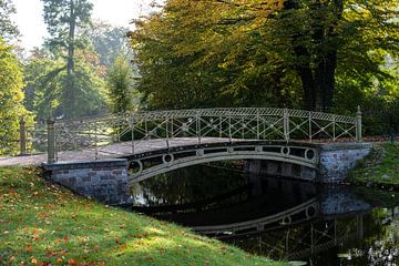 Pedestrian bridge over a canal in the park at the Schwerin castle on a sunny autumn day, copy space, by Maren Winter