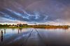 Een mooie regenboog tijdens de zonsopkomst boven het Lauwersmeer in Friesland. In de lucht drijven m van Bas Meelker thumbnail