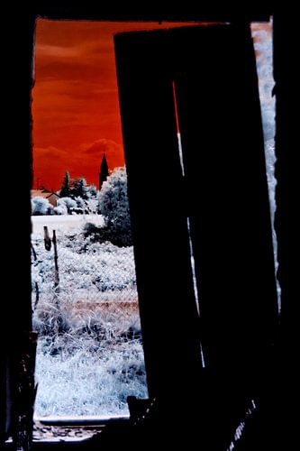 Blood red sky over moonlit countryside