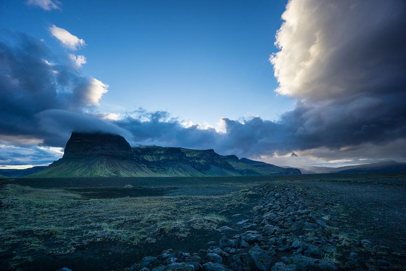 Iceland - Shining clouds hanging over green volcanic mountains b by adventure-photos