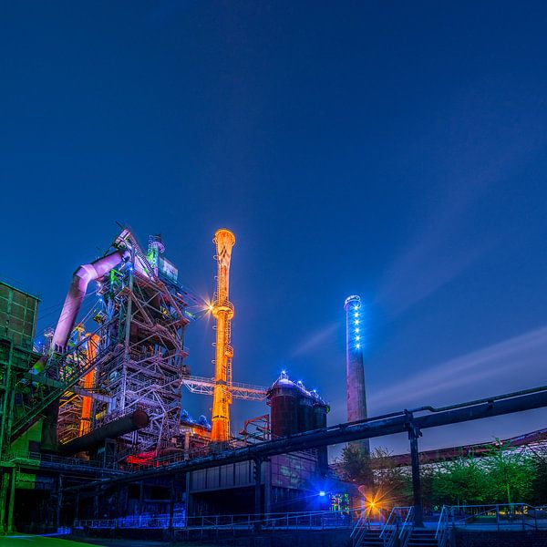 Illuminated factory in the evening by mike van schoonderwalt