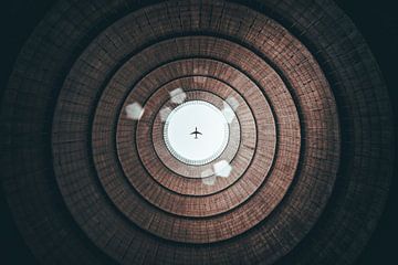 Airplane above a cooling tower by Martijn Van Weeghel
