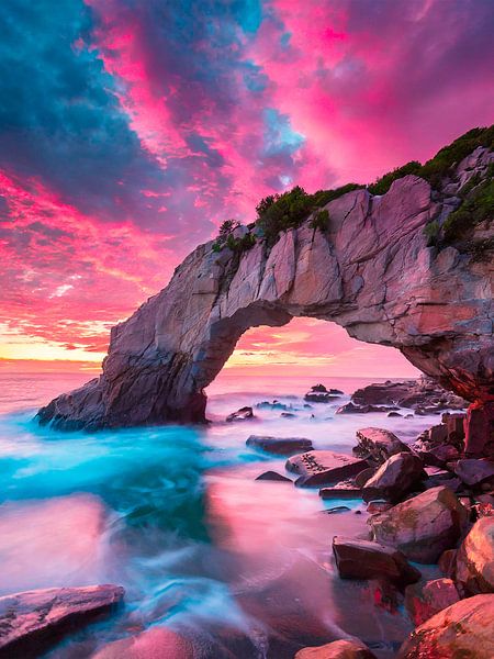 Sunset with rocks on the beach by Mustafa Kurnaz