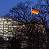 Berlin - dome of Reichstag building with German flag by Frank Herrmann