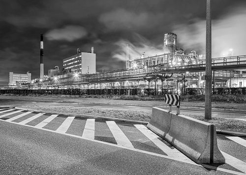Petrochemical production plant at night with road block, Belgium