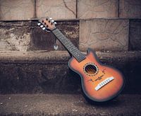 Acoustic guitar made of wood outdoors on a street