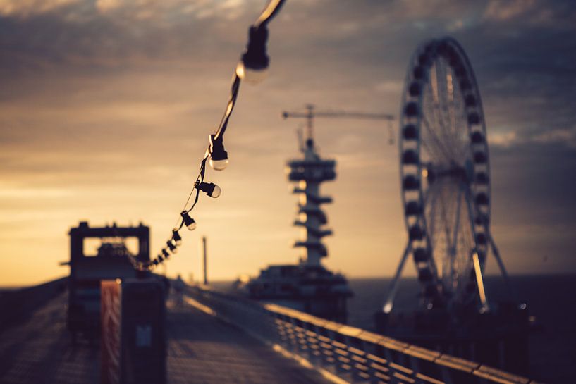 Suspended lamps on a pier during sunset by Christopher A. Dominic