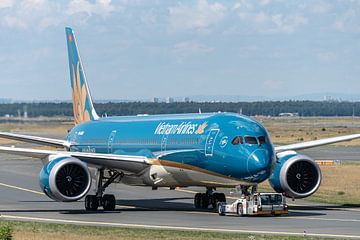 A Vietnam Airlines Boeing 787-9 is towed and brought to the terminal for her departure later in the  by Jaap van den Berg