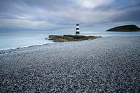 Lighthouse on pebble beach