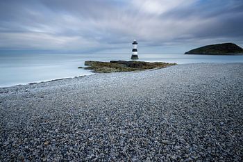 Lighthouse on pebble beach