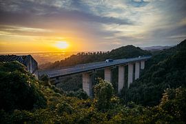 Tuscan viaduct through the mountains during a sunset. by Stefan Lucassen