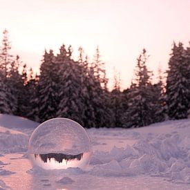 Glass ball buried in the snow by Besa Art