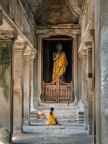Woman praying to Buddha in Angkor Wat, Cambodia