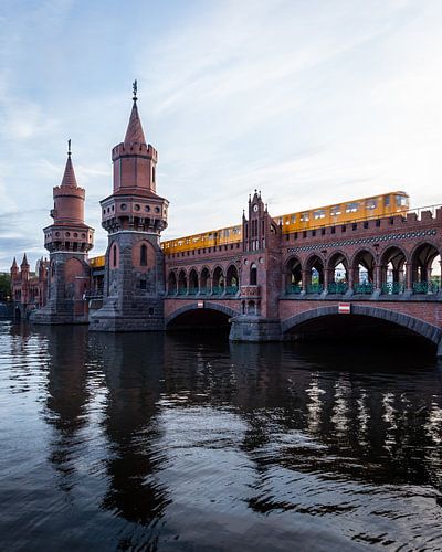 Yellow metro runs across the Oberbaum Bridge in Berlin