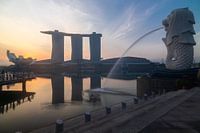 Sunrise at Marina Bay in Singapore overlooking the iconic Merlion and the hotel