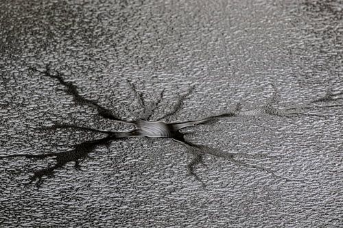 Melting ice, with a thin layer of snow on top, creating a kind of "spider pattern"