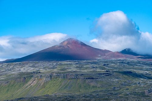 Beautiful sunrise in Iceland. Icelandic landscape with mountains, blue sky and green grass.