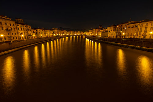 An atmospheric view of the Arno in Pisa by night