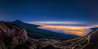 Tenerife in the evening light with starry sky and luminous clouds.