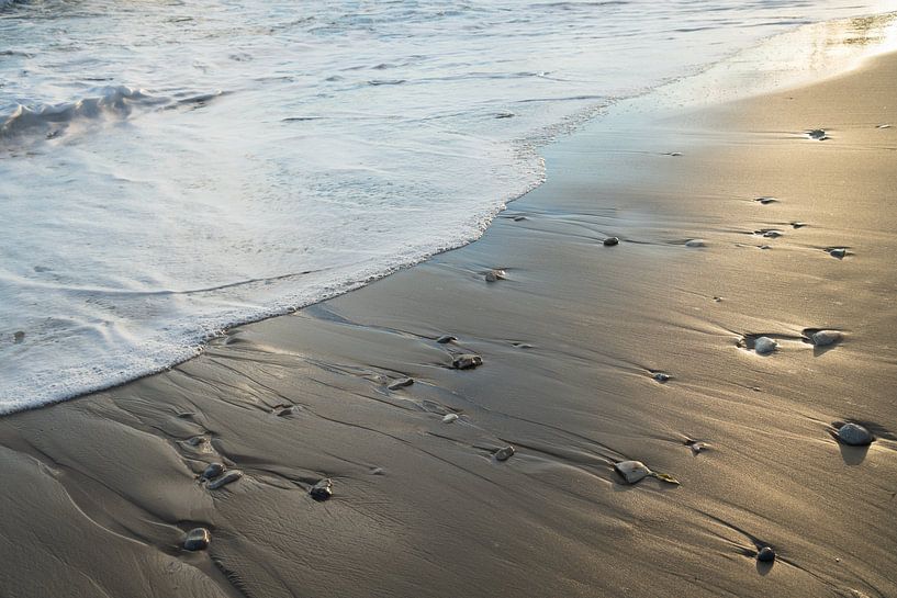 Foaming seawater and shimmering sand by Adriana Mueller