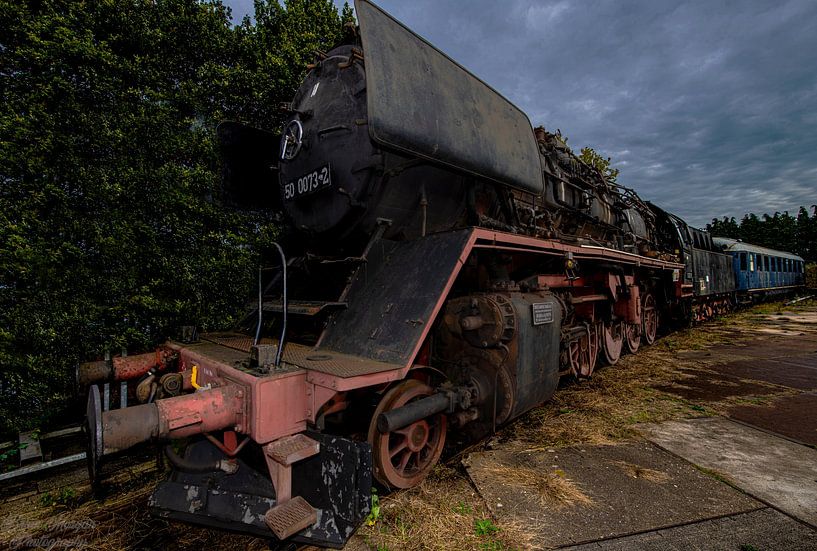 Steam train scrapped and rusty. by Brian Morgan