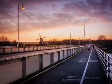 Sunset Symphony: The Wilhelmina Bridge and Bolwerksmolen in Deventer by Bart Ros