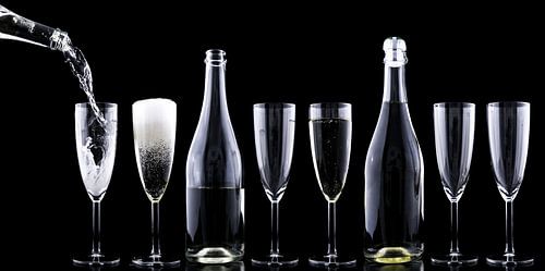 Bouteilles et coupes de champagne dans un décor sombre