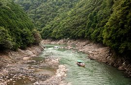 Boat on river in forest, Arashiyama, Kyoto Japan by Sebastian Rollé - travel, nature & landscape photography