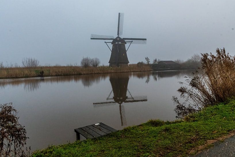 Kinderdijk windmill in the fog by Merijn Loch