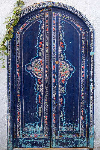 Dark blue Moroccan door with floral motifs