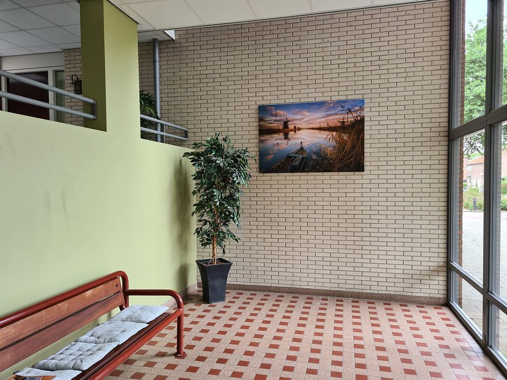 Kinderdijk windmills with boat  by Sander Poppe 