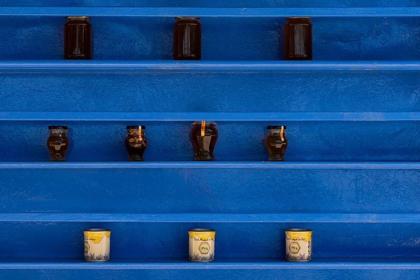 Blue racks with jars of honey at Agios Ioannis Monastery on Kos by Steven Dijkshoorn