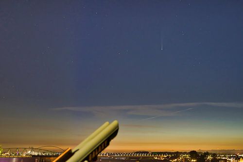 Comet Neowise above the river Waal in evening light.