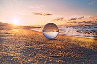 Glass sphere on the beach of Zingst, at sunset. The sun and the Baltic Sea are reflected in the sphe by Martin Köbsch thumbnail
