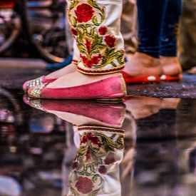 Reflection of colourful kurta in a pond by Leonie Broekstra