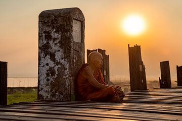 One of the thousands of monks on the U bein bridge in Myanmar enjoys the setting sun by chris mees
