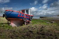 Wooden fishing boat on dry land. Ireland.